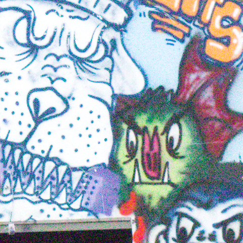 Graffiti on a white wall at ISO 16000, at 1:1, as the camera recorded it