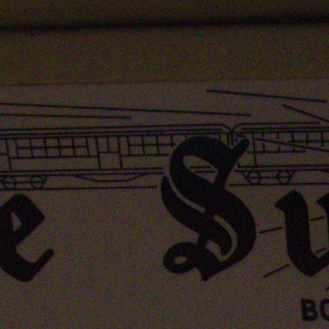 A subway poster's masthead at ISO 4000, at 1:1, as the camera recorded it